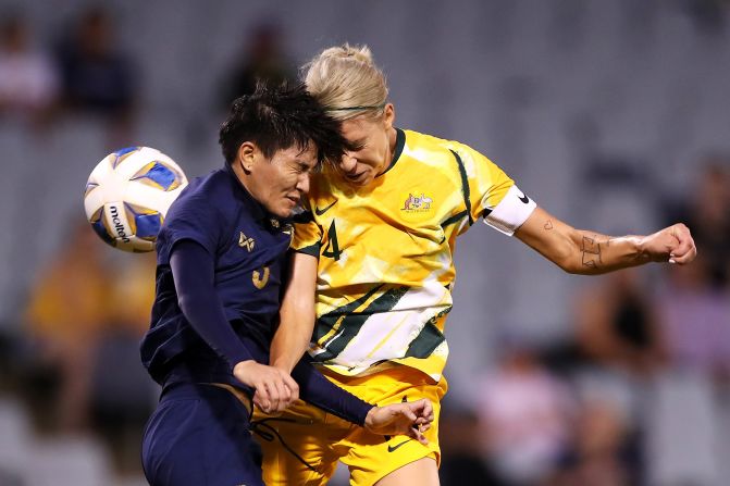 Thailand's Natthakarn Chinwong and Australia's Alanna Kennedy collide as they compete for the ball during the Women's Olympic Football Tournament Qualifier match on February 10, in Sydney, Australia.