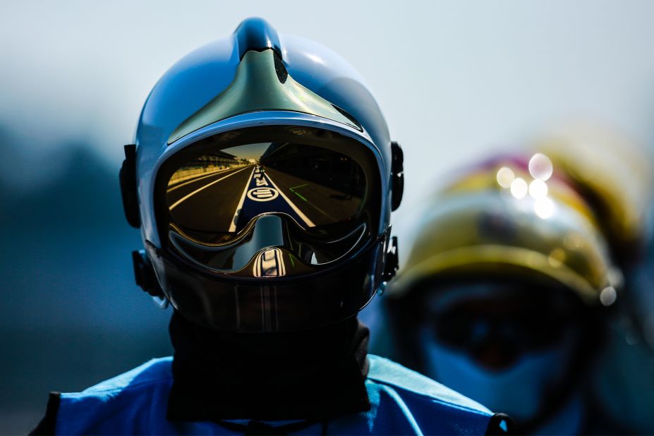 A helmeted fireman watches on as the race unfolds.