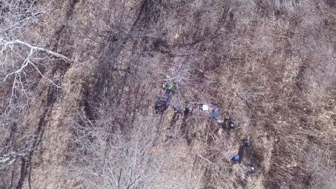 The man is rescued from the woods in this frame grab from drone video.