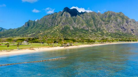 Aerial view of the beach and park at Kualoa with Ko'olau mountains in the background
