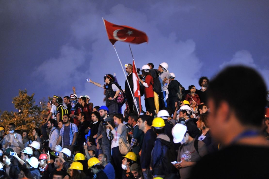 Anti-goverment protesters unfurl the Turkish national flag in Gezi Park in June 2013.