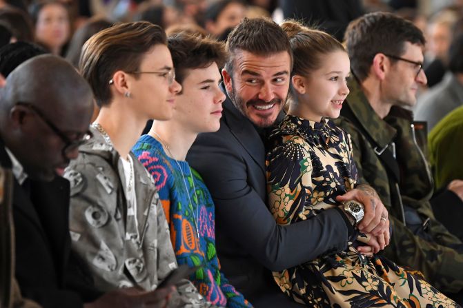 Sons of David and Victoria Beckham, Romeo and Cruz , David Beckham and his daughter Harper take their seats in the front row.