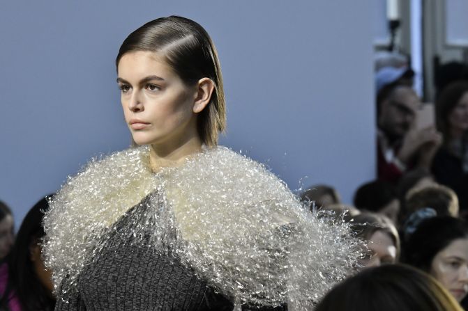 Kaia Gerber walks the runway at the JW Anderson show adorned in shimmering knit.