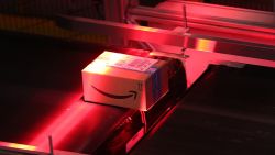 A red light scans a parcel on a conveyor belt inside an Amazon.com Inc. fulfilment center at an Amazon.com Inc. fulfilment center during the online retailer's Prime Day sales promotion day in Koblenz, Germany, on Monday, July 15, 2019. Amazon is tapping high-profile actors, athletes and social-media sensations like never before to maintain buzz around its Prime Day summer sale, now in its fifth year and battling increasing competition from rivals. Photographer: Krisztian Bocsi/Bloomberg via Getty Images