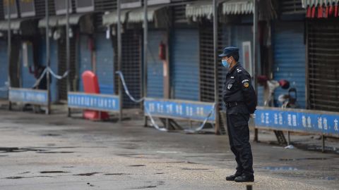 A security guard stands outside the Huanan Seafood Wholesale Market where the coronavirus was detected in Wuhan on January 24.