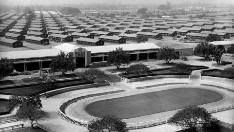 The Santa Anita Park race track is converted into an internment for evacuated Japanese Americans who will occupy the barracks erected in background.