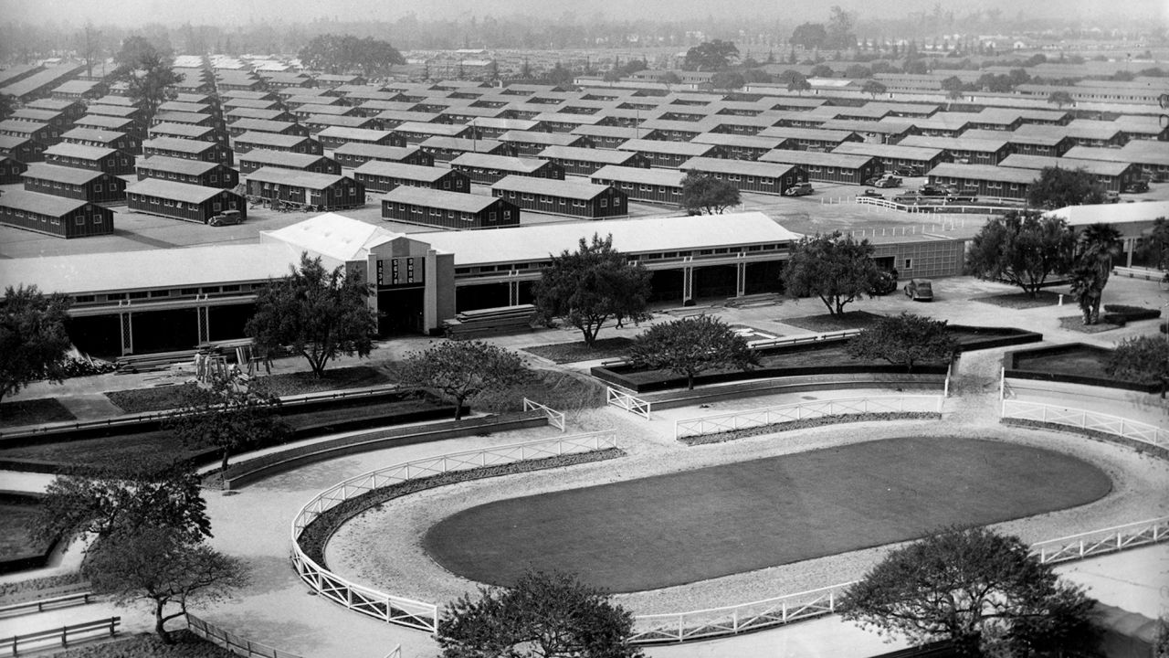 The Santa Anita Park race track is converted into an internment for evacuated Japanese Americans who will occupy the barracks erected in background.
