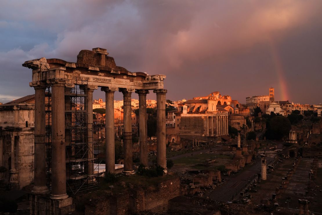 A rainbow over the ruins of the ancient Roman Forum during a sunset