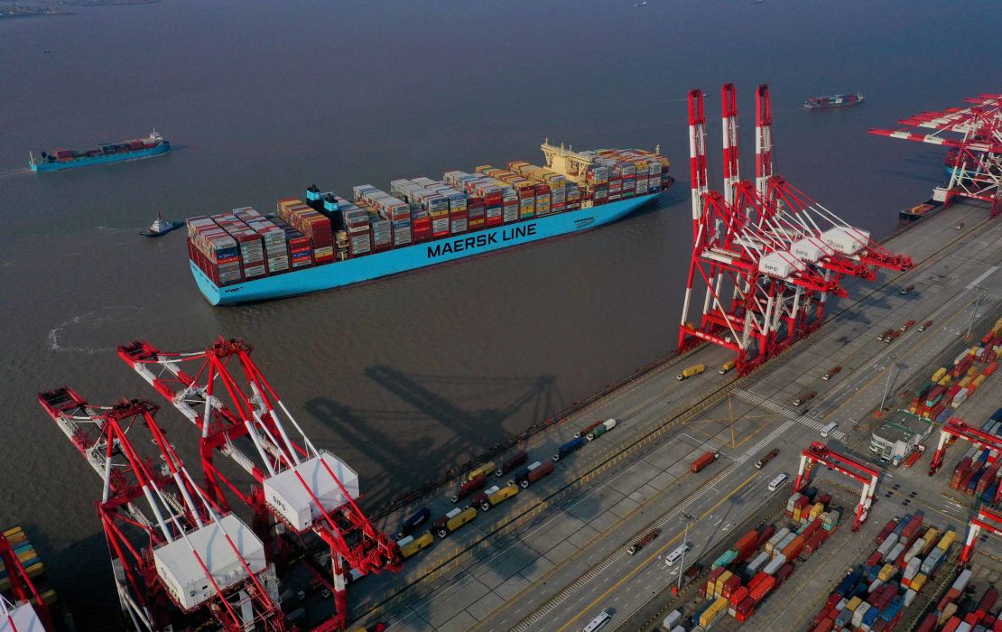 Tugboats guide a Maersk container ship in Shanghai.