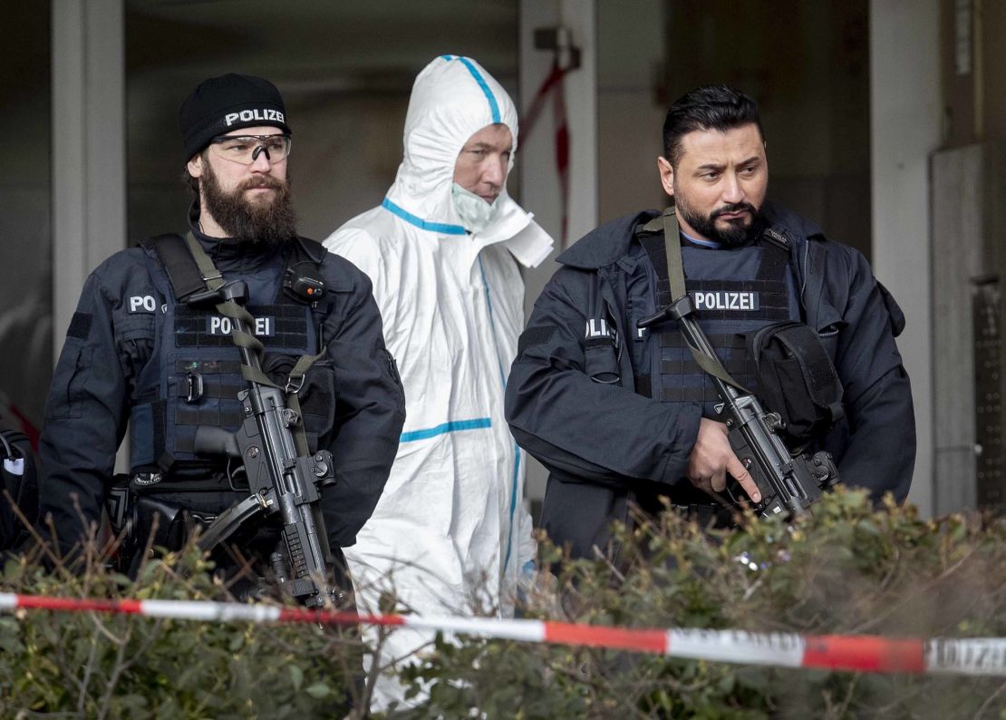 Police officers guard the entrance of a bar where several people were killed late Wednesday in Hanau, Germany.