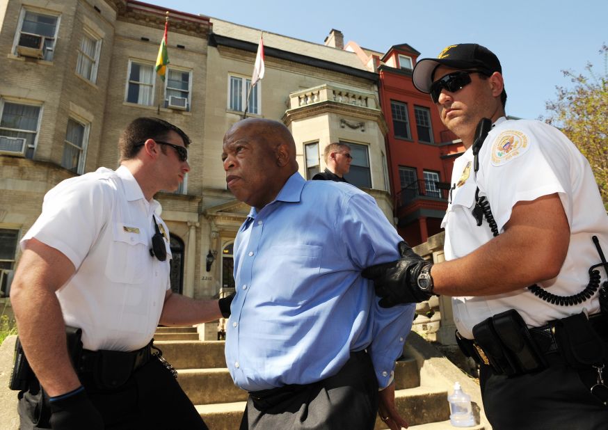 Lewis is led away in handcuffs by a Secret Service officer in Washington, DC, as he protested Sudan's Darfur conflict in April 2009.