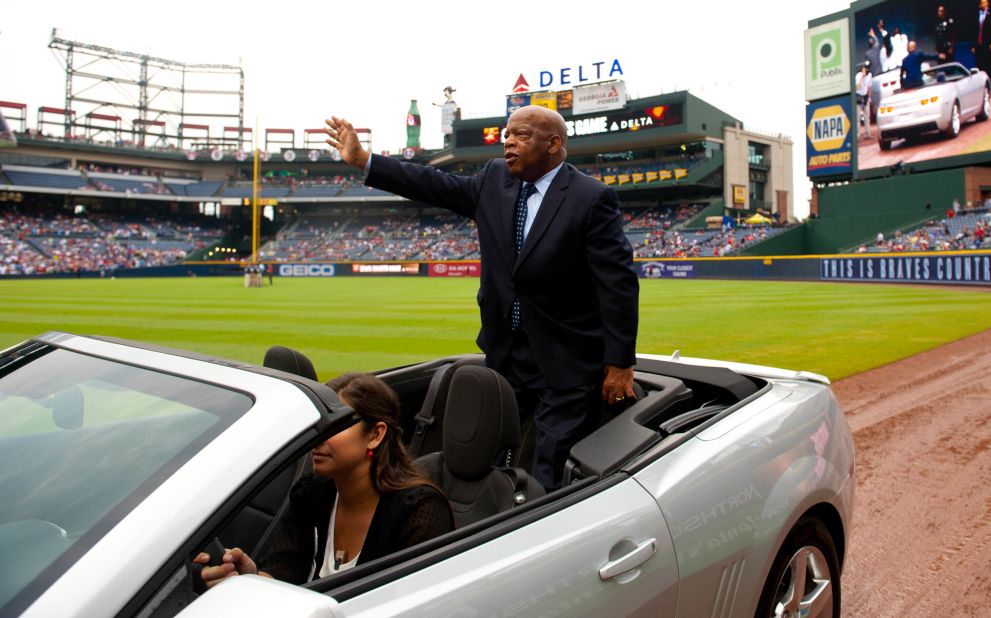 Lewis acknowledges the crowd as he is driven around the diamond at an Atlanta Braves baseball game at Turner Field in August 2012.
