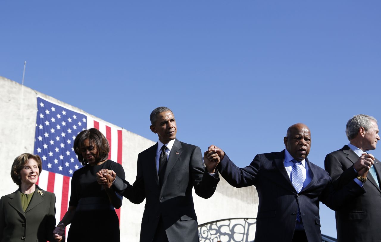 Lewis holds hands with Obama and former President George W. Bush during the 50th anniversary event at Selma's Edmund Pettus Bridge.