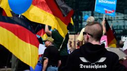 Alternative for Germany (AfD)'s demonstrators holding AfD and German flags gather at the main station in Berlin to attend the "demonstration for the future of Germany" in Berlin on May 27, 2018.