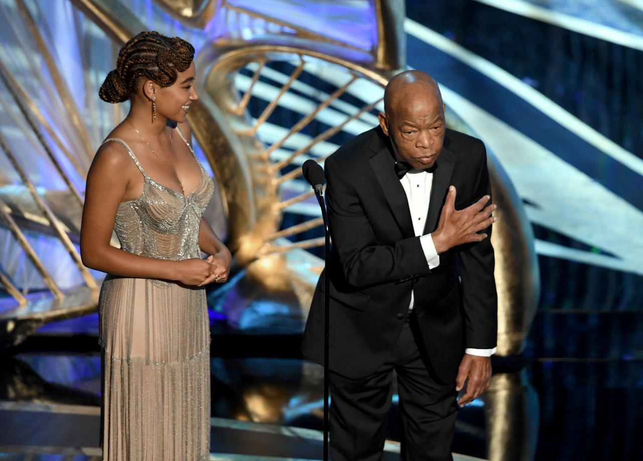 Lewis, standing next to actress Amandla Stenberg, speaks on stage during the Academy Awards in February 2019. He was introducing the movie "Green Book," which went on to win best picture.