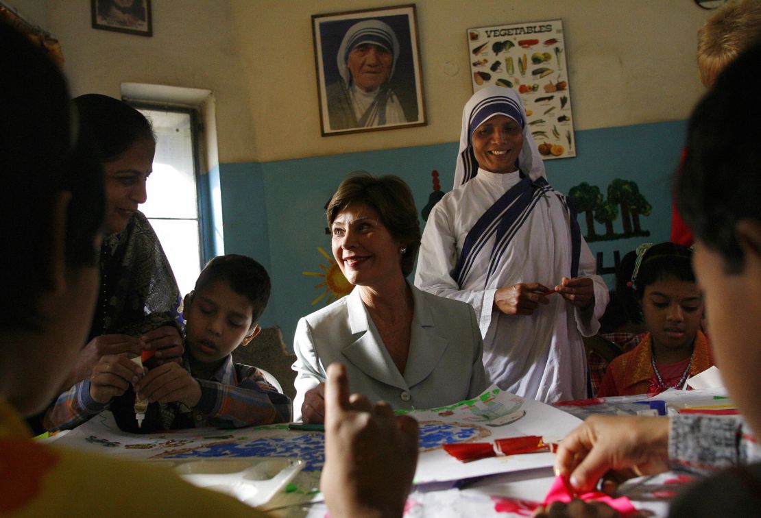 Laura Bush listens to children sing  at Jeevan Jyoti (Mother Teresa's) home for disabled children in New Delhi.