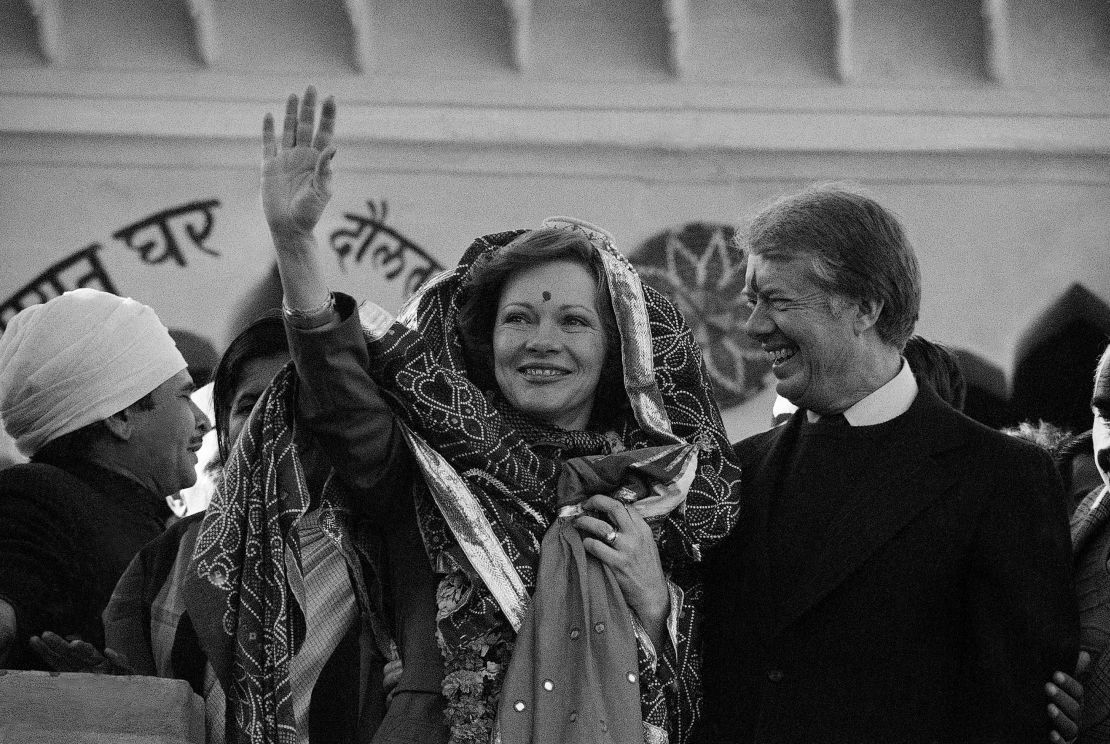 Rosalynn Carter waves to villagers in Daulatpur Nasirabad, a town 17 miles from New Delhi, in January 1978 after she received a colorful shawl as a gift. 