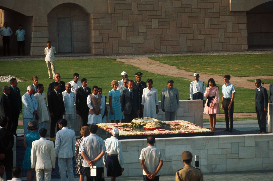 Pat Nixon pays homage at the shrine of Mahatma Gandhi, along with her husband, then-President Richard Nixon and Indian government officials.