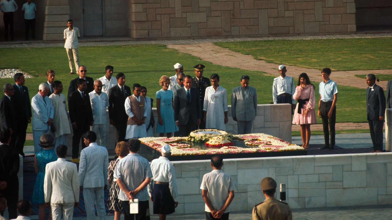 Pat Nixon pays homage at the shrine of Mahatma Gandhi, along with her husband, then-President Richard Nixon and Indian government officials.