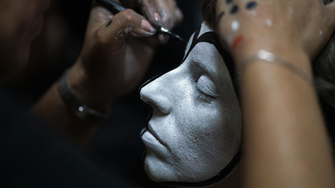 <strong>Montevideo, Uruguay: </strong>A woman applies makeup to a drummer's face in preparation for Las Llamadas, the Uruguayan Carnival that has its roots in the traditions of African slaves, on Friday, February 14.