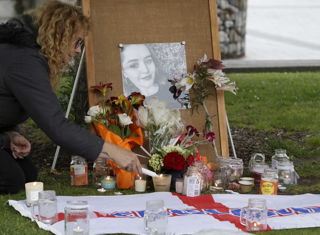 A woman lights candles during a vigil for murdered British tourist Grace Millane at Cathedral Square in Christchurch, New Zealand, in December 2018.
