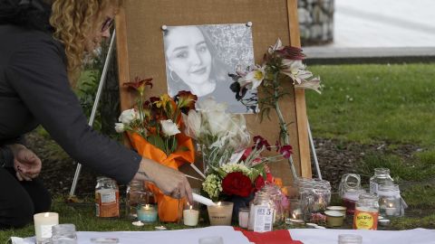 A woman lights candles during a vigil for murdered British tourist Grace Millane at Cathedral Square in Christchurch, New Zealand, in December 2018.