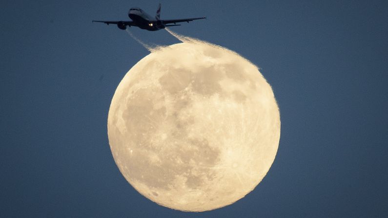 <strong>London: </strong>A plane flies in a moonlit sky in this photo taken in Richmond Park, southwest London, on February 8. 