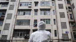 WUHAN, Feb. 7, 2020  -- A community worker stands in front of a residential building as he prepares to conduct a health check in Caidian District of Wuhan, central China's Hubei Province, Feb. 7, 2020. Wuhan, the epicenter of the novel coronavirus outbreak, is combing communities to ensure every confirmed or suspected patient is located and attended to. (Photo by Cheng Min/Xinhua via Getty) (Xinhua/Cheng Min via Getty Images)
