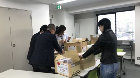 Japan Youth Development Association staff  pack emergency medical supplies. They had to send the boxes in three batches as the post offices were inundated with supplies being sent  to China. 