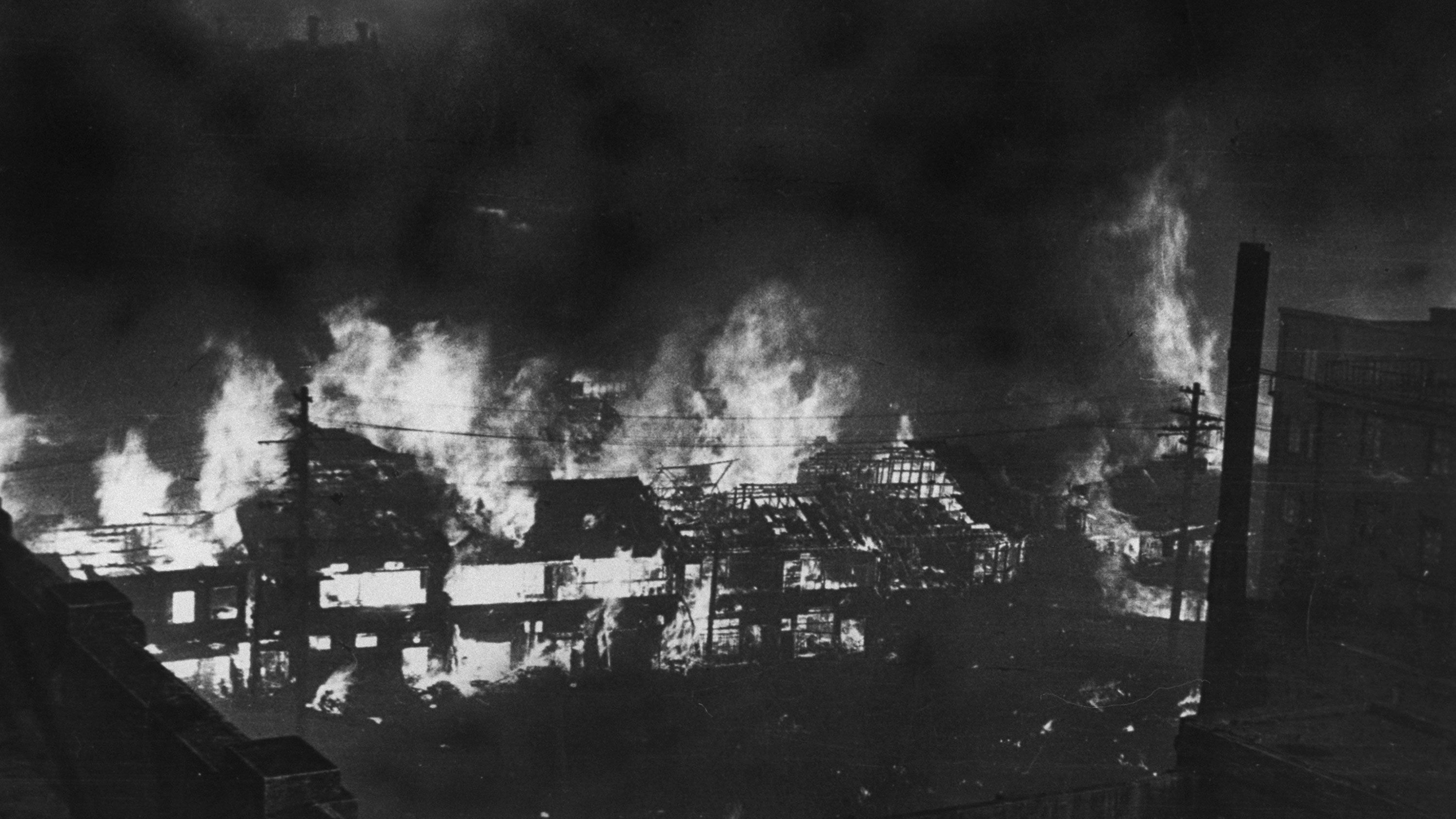 Japanese government photo shows buildings aflame after World War II firebomb raid.