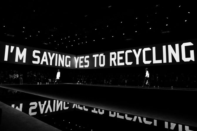 A message projected at Emporio Armani's show which was live-streamed amid coronavirus fears 