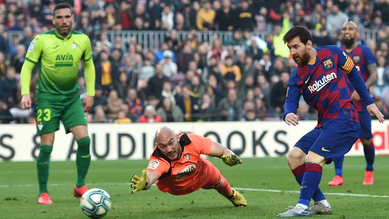 Lionel Messi slots home his fourth goal past a despairing Eibar goalkeeper in the closing stages of the 5-0 win at the Camp Nou.