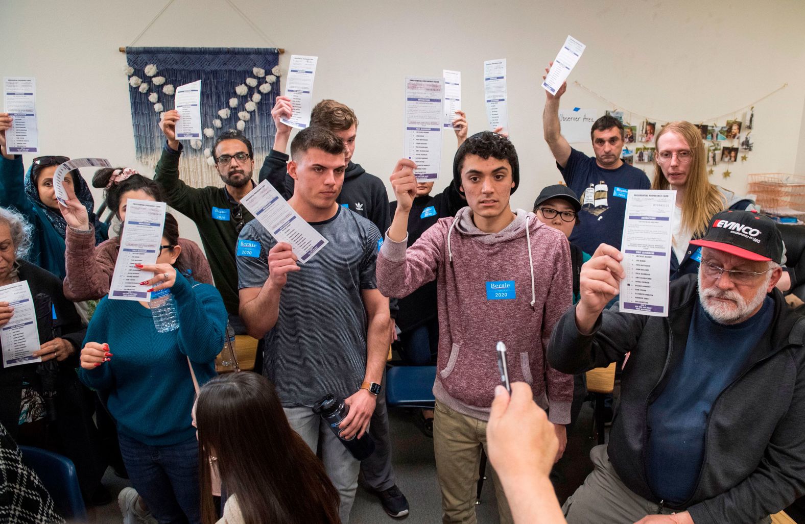 A volunteer counts votes during a caucus in Henderson.