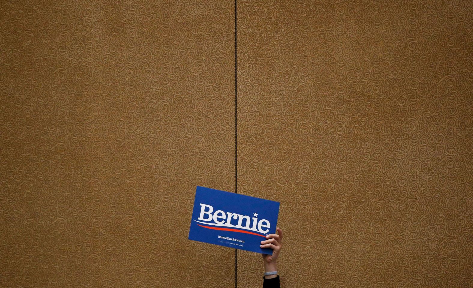 A Sanders supporter holds up a sign during the caucus at the Bellagio hotel in Las Vegas.