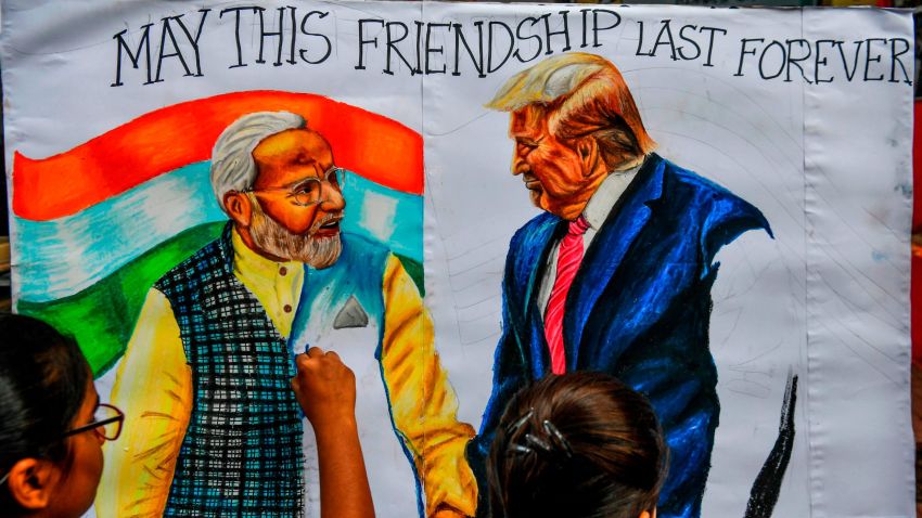 TOPSHOT - Students paint on canvas faces of US President Donald Trump (R) and India's Prime Minister Narendra Modi, in the street in Mumbai on February 21, 2020, ahead of the visit of US President in India. (Photo by INDRANIL MUKHERJEE / AFP) (Photo by INDRANIL MUKHERJEE/AFP via Getty Images)
