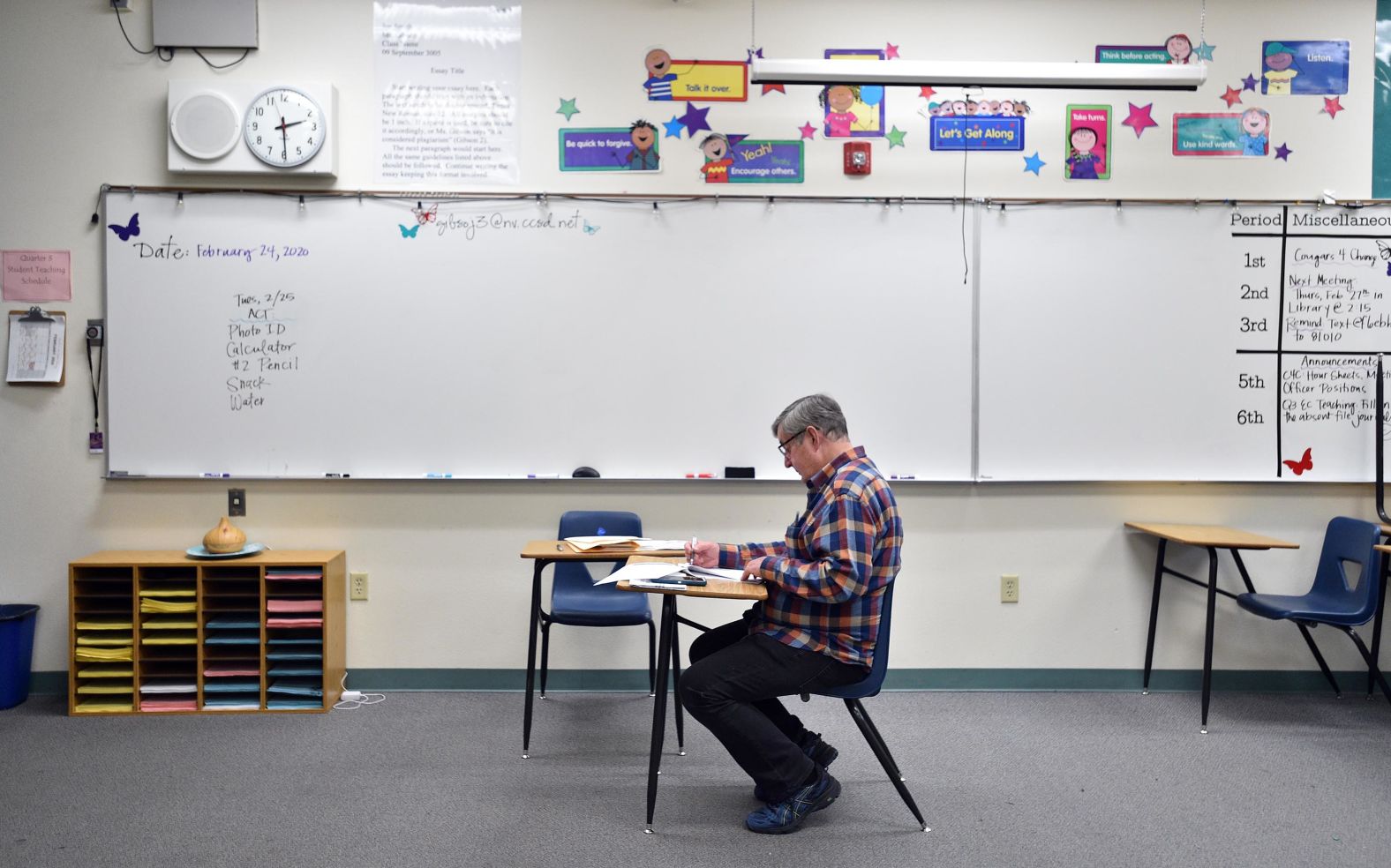 A precinct chairman checks paperwork before submitting the final count at Henderson's Coronado High School.