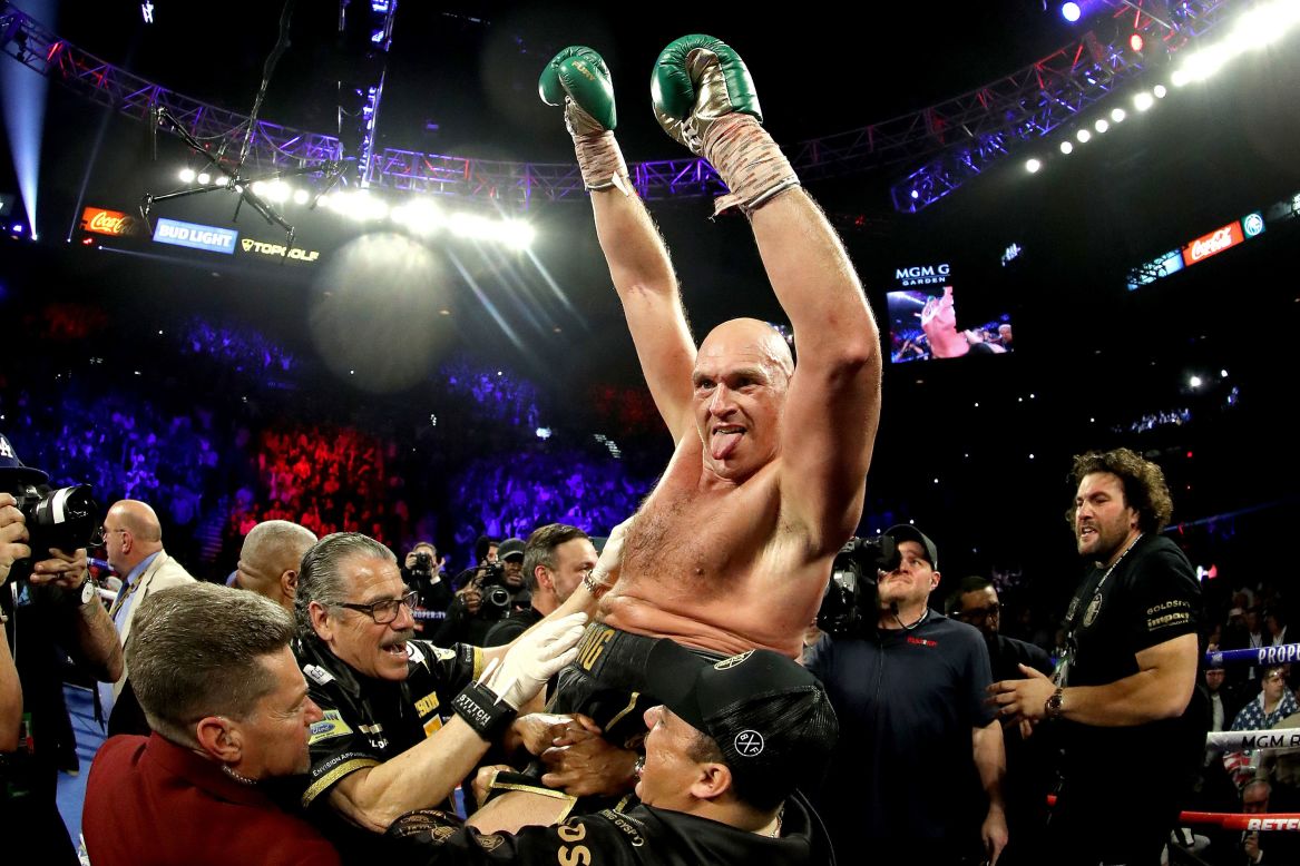 Fury celebrates his win by TKO in the seventh round against Wilder.