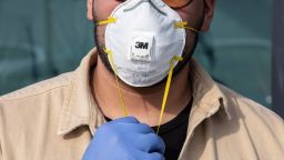 A man wearinig a respiratory mask and gloves is pictured on February 23, 2020 in Casalpusterlengo, south-west Milan, Italy.
