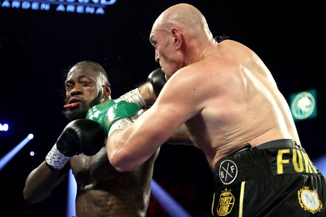 Tyson Fury, right, lands a punch on Deontay Wilder during their heavyweight bout <a href="index.php?page=&url=https%3A%2F%2Fwww.cnn.com%2F2020%2F02%2F23%2Fsport%2Ffury-wilder2-heavyweight-title-rematch-las-vegas%2Findex.html" target="_blank">for Wilder's WBC and Fury's lineal heavyweight title</a> on February 22 in Las Vegas, Nevada. Fury took home the title.