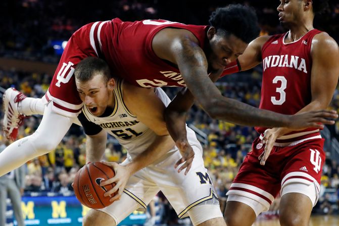 Indiana forward De'Ron Davis falls over Michigan forward Austin Davis during the second half of an NCAA college basketball game in Ann Arbor, Michigan, on February 16.