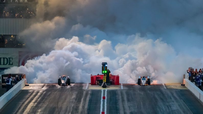 Smoke fills the air as a pair of NHRA jet dragsters launch off the starting line at Wild Horse Pass Motorsports Park on February 21.