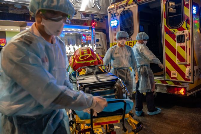 Paramedics carry a stretcher off an ambulance in Hong Kong on February 23, 2020.