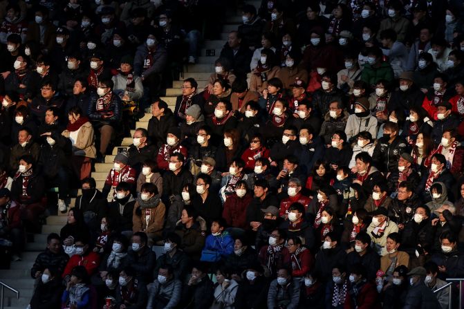 People attend a professional soccer match in Kobe, Japan, on February 23, 2020. To help stop the spread of the novel coronavirus, the soccer club Vissel Kobe <a href="index.php?page=&url=https%3A%2F%2Fwww.espn.com%2Fsoccer%2Fvissel-kobe%2Fstory%2F4057914%2Finiestas-vissel-kobe-ban-singing-chanting-due-to-coronavirus-threat" target="_blank" target="_blank">told fans not to sing, chant or wave flags</a> in the season opener against Yokohama FC.