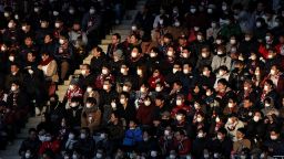 This picture taken on February 23, 2020 shows audience members wearing face masks at a J.League football match between Vissel Kobe and Yokohama F. Marinos in Kobe. - The Japanese government has urged people to avoid large gatherings, and Tokyo's government has cancelled some large public events over COVID-19 coronavirus fears that has now killed more than 2,400 people and spread around the world. 
