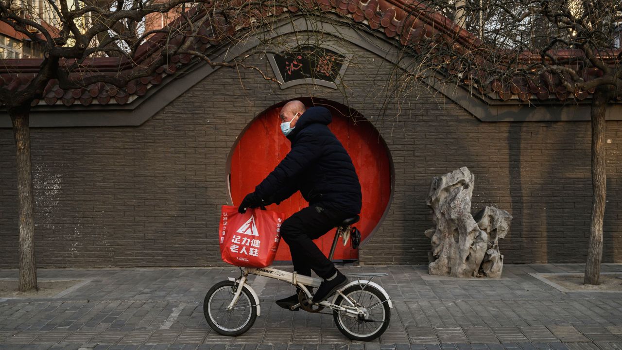 A Chinese man wears a protective mask as he rides his bike on February 23, 2020 in Beijing, China. The number of cases of the deadly new coronavirus COVID-19 being treated in China was more than 55000  in mainland China Saturday, in what hat the World Health Organization (WHO) has declared a global public health emergency. China continued to lock down the city of Wuhan in an effort to contain the spread of the pneumonia-like disease which medicals experts have confirmed can be passed from human to human. In an unprecedented move, Chinese authorities have maintained and in some cases tightened the travel restrictions on the city which is the epicentre of the virus and also in municipalities in other parts of the country affecting tens of millions of people. The number of those who have died from the virus in China climbed to over 2348 on Saurday mostly in Hubei province, and cases have been reported in other countries including the United States, Canada, Australia, Japan, South Korea, India, the United Kingdom, Germany, France and several others. The World Health Organization has warned all governments to be on alert and screening has been stepped up at airports around the world. Some countries, including the United States, have put restrictions on Chinese travellers entering and advised their citizens against travel to China.