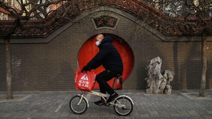 A Chinese man wears a protective mask as he rides his bike on February 23, 2020 in Beijing, China. The number of cases of the deadly new coronavirus COVID-19 being treated in China was more than 55000  in mainland China Saturday, in what hat the World Health Organization (WHO) has declared a global public health emergency. China continued to lock down the city of Wuhan in an effort to contain the spread of the pneumonia-like disease which medicals experts have confirmed can be passed from human to human. In an unprecedented move, Chinese authorities have maintained and in some cases tightened the travel restrictions on the city which is the epicentre of the virus and also in municipalities in other parts of the country affecting tens of millions of people. The number of those who have died from the virus in China climbed to over 2348 on Saurday mostly in Hubei province, and cases have been reported in other countries including the United States, Canada, Australia, Japan, South Korea, India, the United Kingdom, Germany, France and several others. The World Health Organization has warned all governments to be on alert and screening has been stepped up at airports around the world. Some countries, including the United States, have put restrictions on Chinese travellers entering and advised their citizens against travel to China.