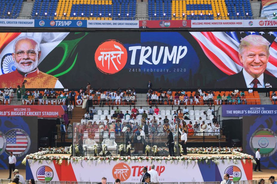 Workers clean a bulletproof-glass enclosure around the podium before the rally started on Monday.