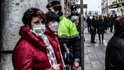 People wearing protective masks in Venice, Italy, on February 23, 2020 due to concerns over coronavirus infection during the The Eagle Flight for the carnival of Venice. More than 130 are infected with Coronavirus (Covid-19) in Italy.  Authorities in some Lombardy and Veneto towns closed schools, businesses and restaurants, and cancelled sporting events and religious services. (Photo by Manuel Romano/NurPhoto via Getty Images)
