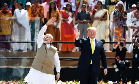 Modi and Trump wave to the crowd at India's largest cricket stadium.