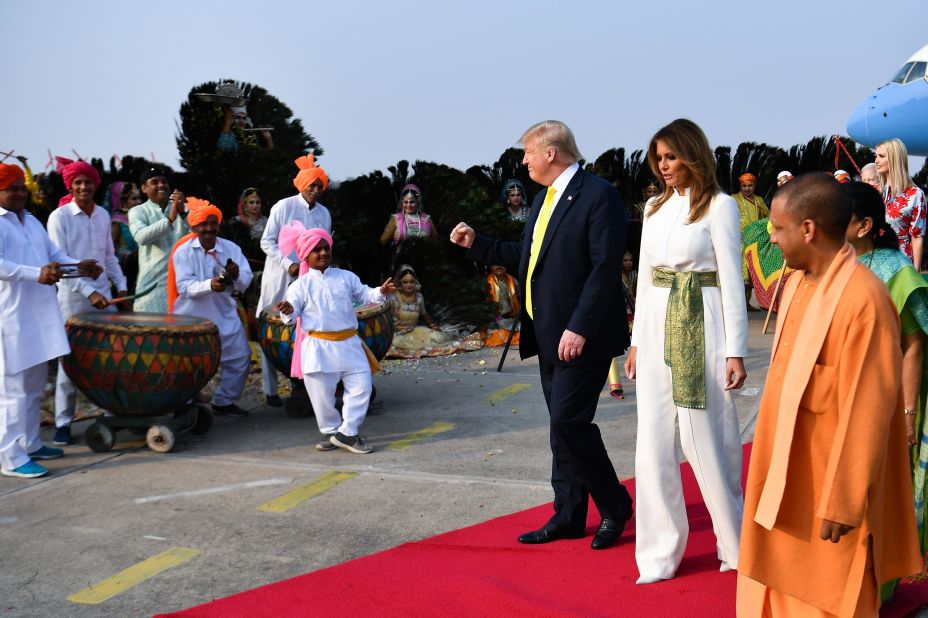 The Trumps are greeted by performers wearing traditional costumes as they arrive at Agra Air Base on Monday.
